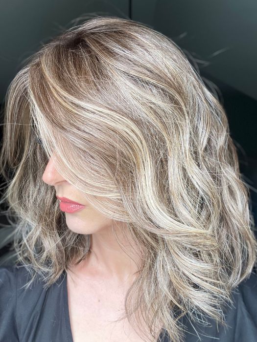 Sandy @i_be_wiggin wearing WAVY DAY by RAQUEL WELCH WIGS in color RL9/24SS ICED CAFÉ LATTE | Dark Brown shaded with Golden Brown