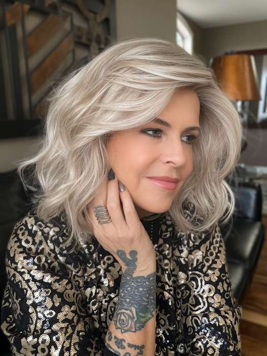 Donna @style.me.ageless wearing CALIENTE by BELLETRESS in color BUTTERBEER-BLONDE | Cool Light Blonde, Light Ash Blonde, and Golden Blonde with Medium Brown Roots