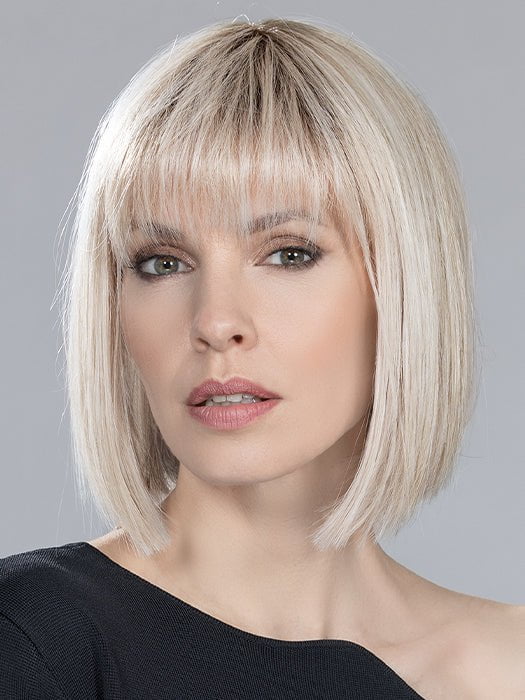 A stylish bob wig with blunt cut bangs and uniform mid-length