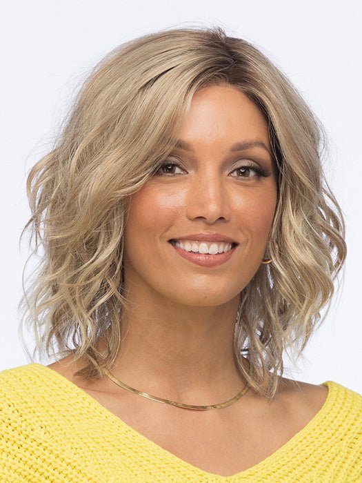 This synthetic wig has subtle layers and free-flowing waves for a cute shoulder-length hairstyle